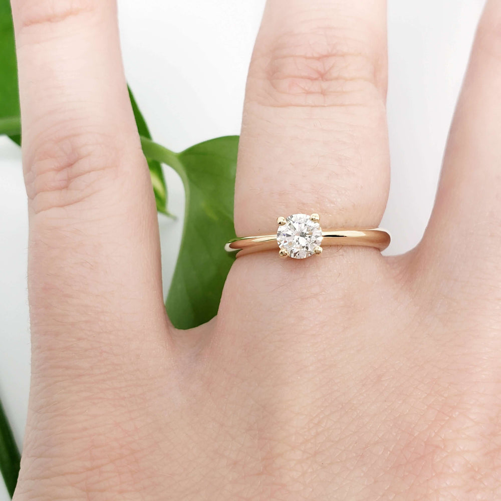 14kt yellow gold diamond solitaire ring shown on hand