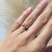 Emerald cut lab diamond ring in 14kt yellow gold shown on hand