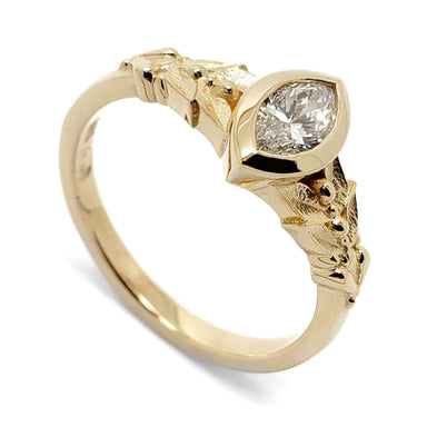14kt yellow gold engagement ring with bezel-set marquise lab diamond and leaf details
