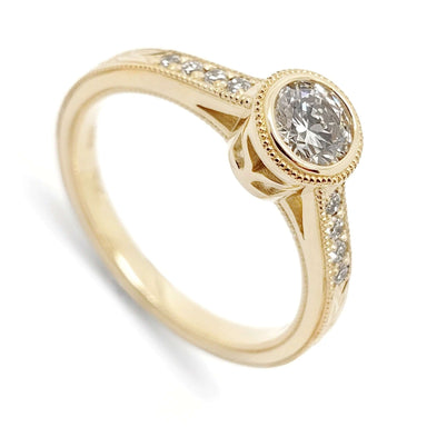 14kt yellow gold engagement ring with bezel-set round lab diamond and pave band