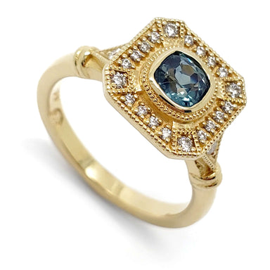 14kt yellow gold engagement ring with cushion cut blue Montana sapphire and diamond halo
