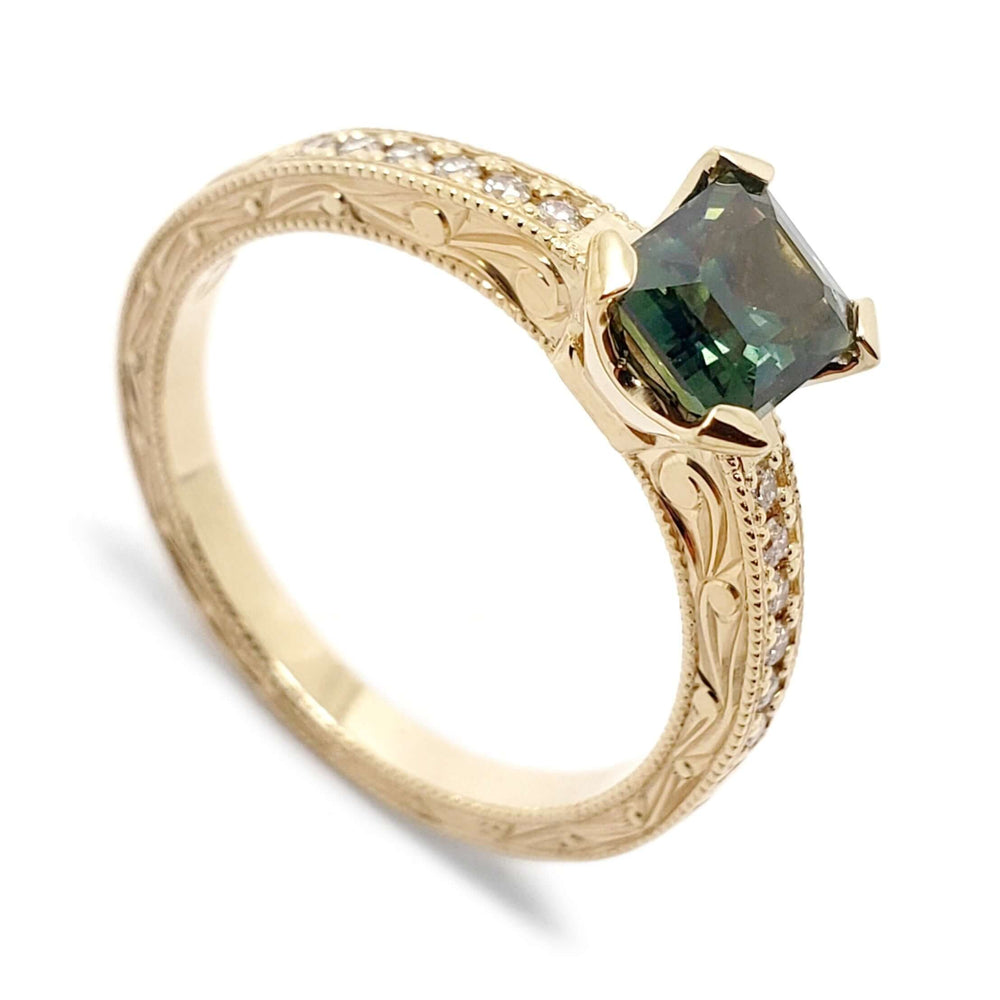 14kt yellow gold engagement ring with emerald cut teal Australian sapphire and Canadian diamonds, engraved band