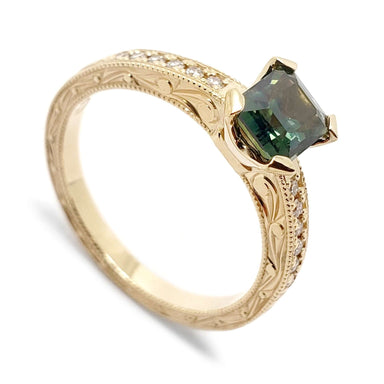 14kt yellow gold engagement ring with emerald cut teal Australian sapphire and Canadian diamonds, engraved band