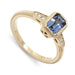 14kt yellow gold engagement ring with emerald cut blue sapphire and diamond accents