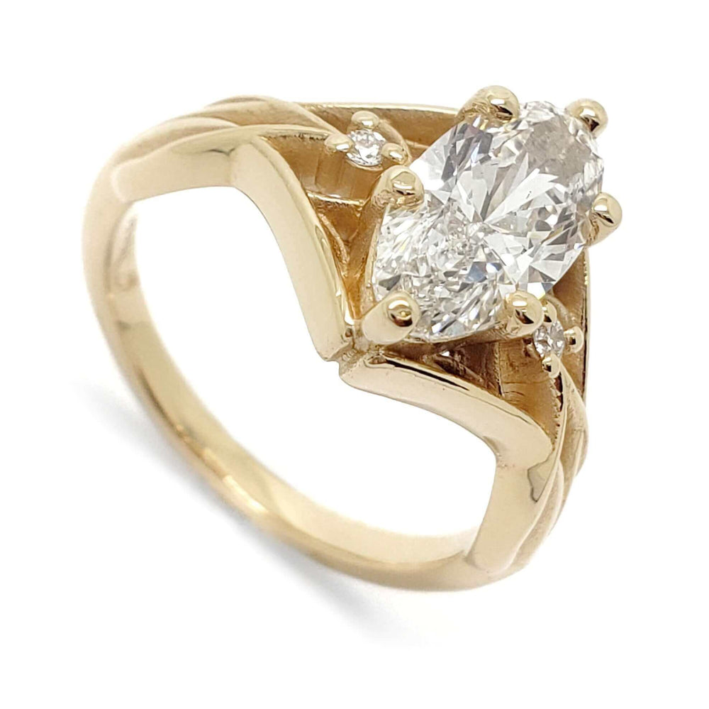 14kt yellow gold engagement ring with marquise-oval lab diamond and side diamonds, angled view