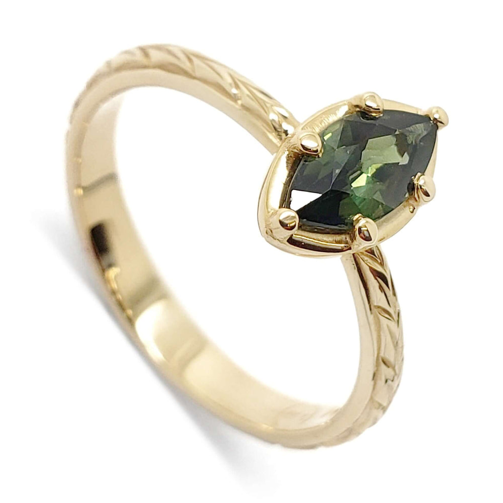 14kt yellow gold engagement ring with marquise cut green sapphire and hand engraving