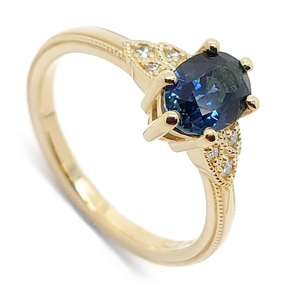 14kt yellow gold engagement ring with oval blue Montana sapphire and Canadian diamonds