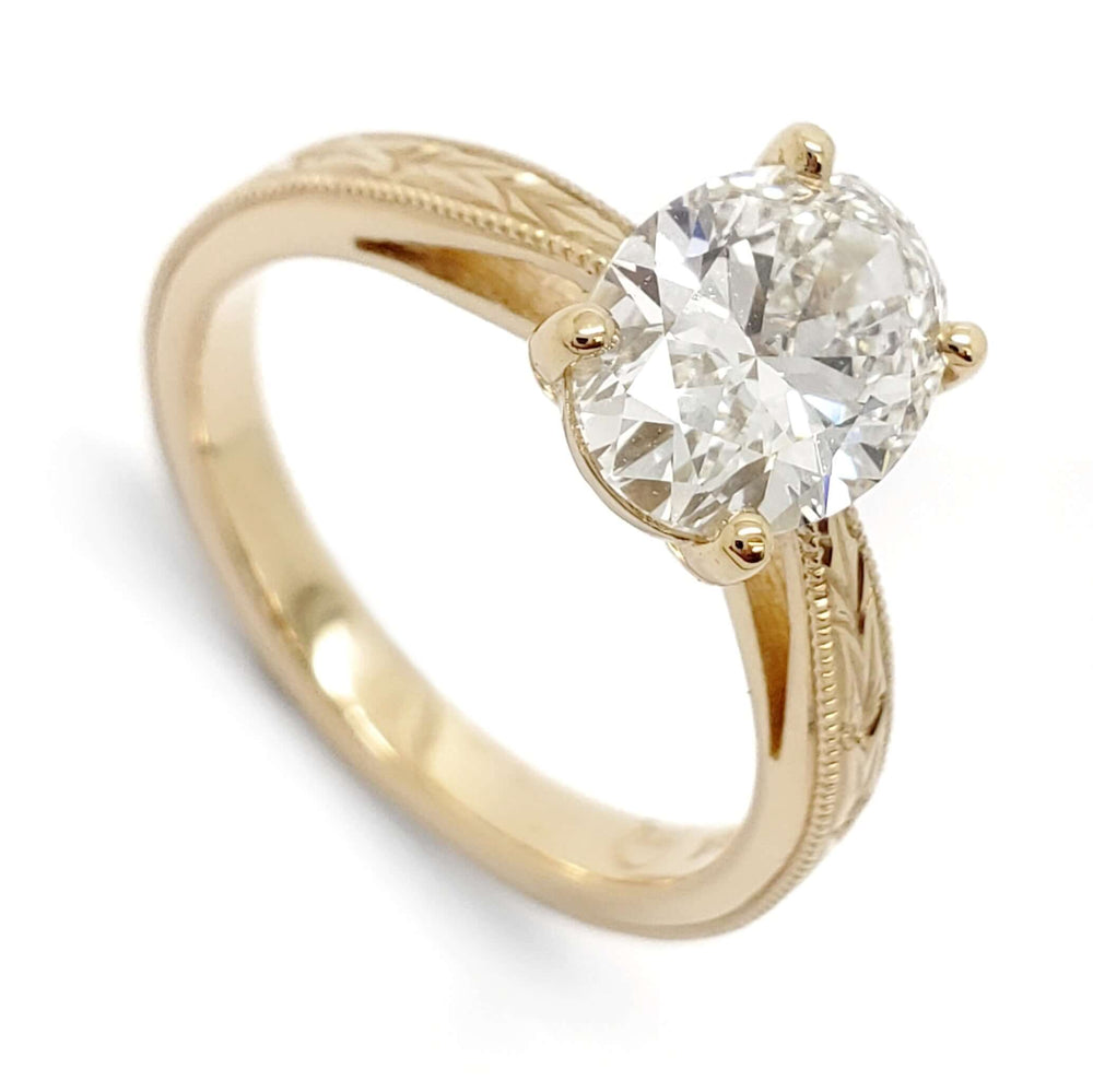 14kt yellow gold engagement ring with oval lab diamond and hand engraved band