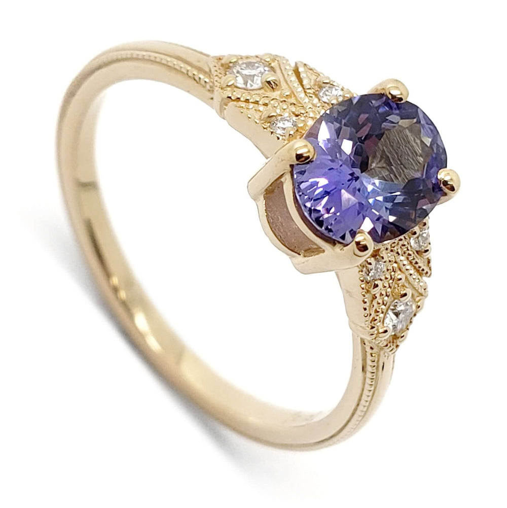 14kt yellow gold engagement ring with oval purple-blue sapphire and diamond accents
