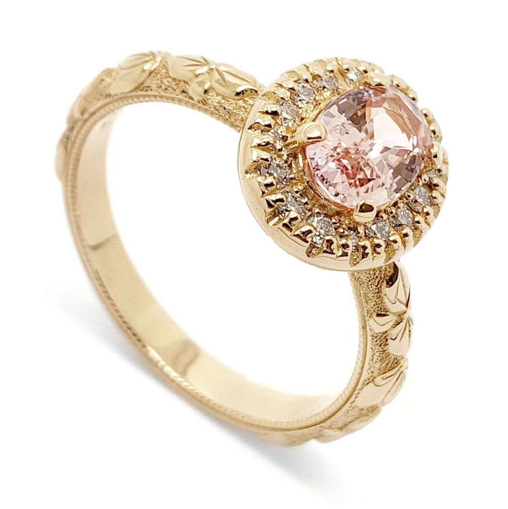 14kt yellow gold engagement ring with oval peach sapphire and diamond halo, floral engraved band