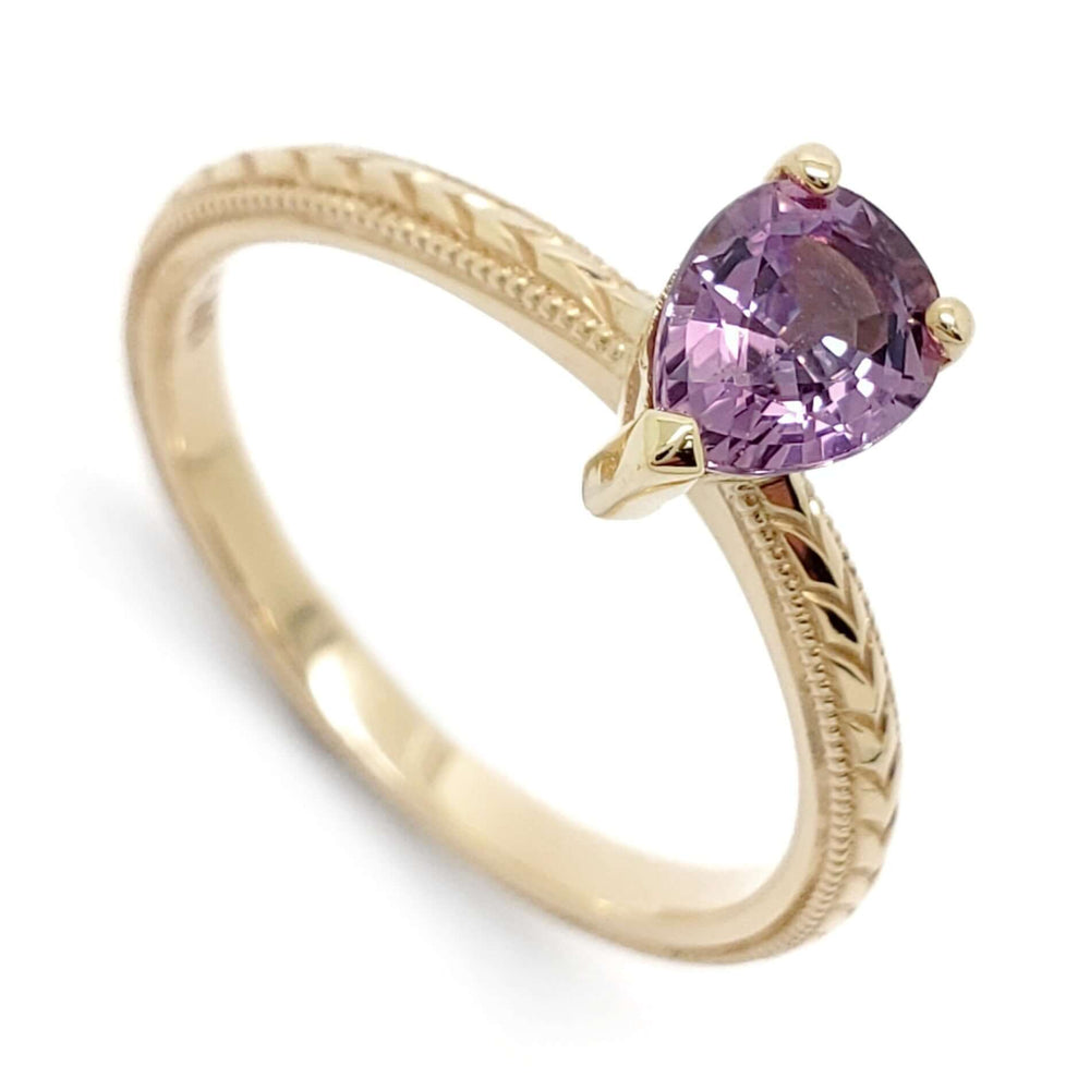 14kt yellow gold engagement ring with pear cut pink sapphire and hand engraving
