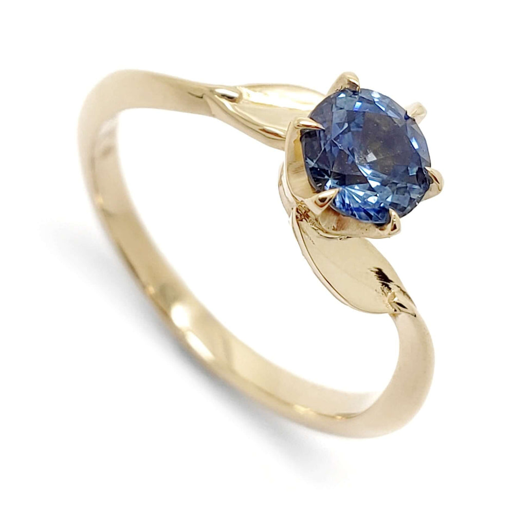 14kt yellow gold engagement ring with round blue Montana sapphire and leaf detail
