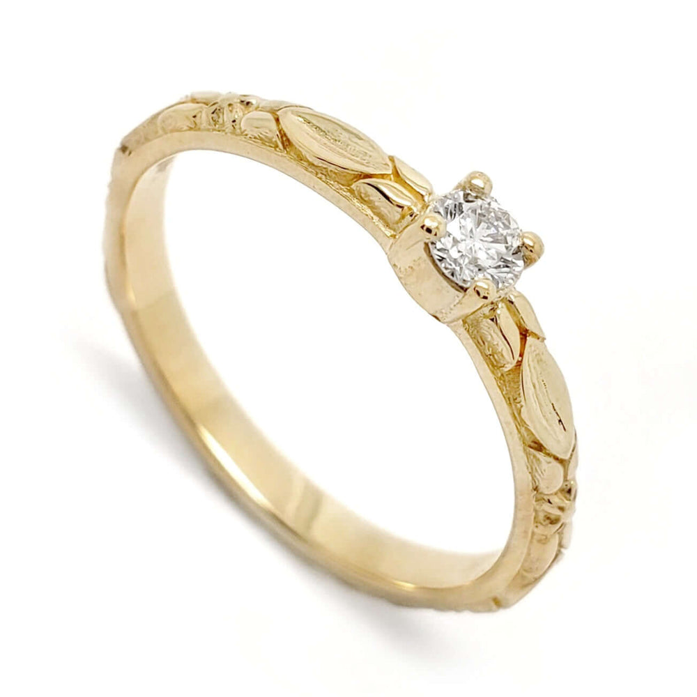 14kt yellow gold engagement ring with a round brilliant diamond and raised leaf details