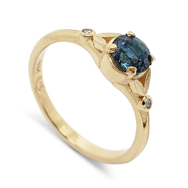 14kt yellow gold engagement ring with teal Montana sapphire and Canadian diamonds