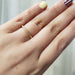 14kt yellow gold engraved wedding ring worn on a hand