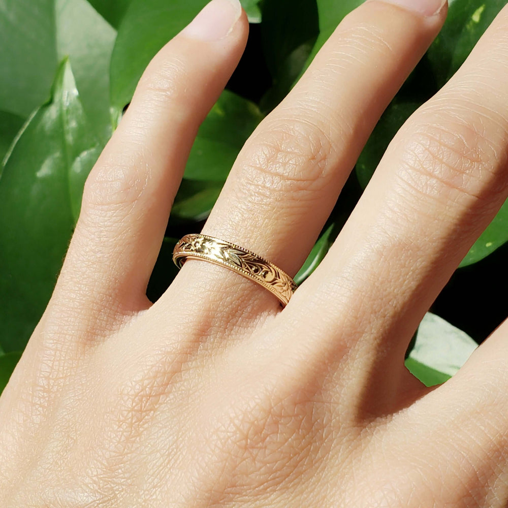 14kt yellow gold engraved wedding ring worn on hand