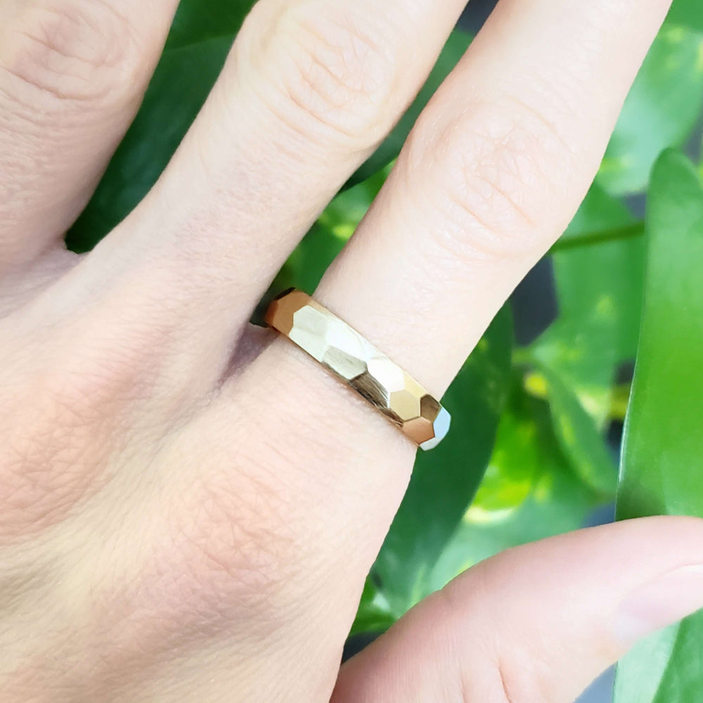 14kt yellow gold faceted wedding ring shown on hand