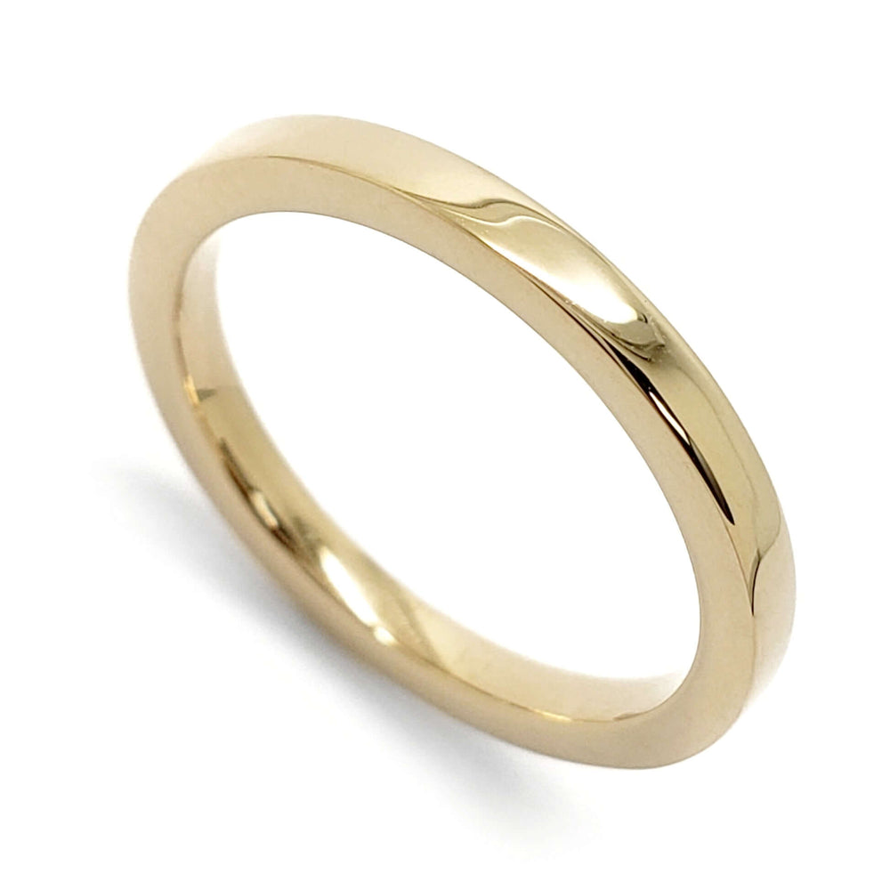 14kt yellow gold flat polished wedding ring on white background