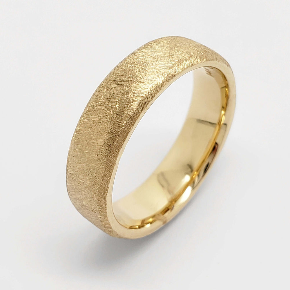 14kt yellow gold flat wedding band with rolled edge and saw blade finish
