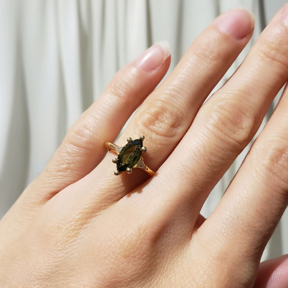 14kt yellow gold green sapphire and lab diamond ring shown on hand