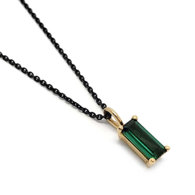 14kt yellow gold pendant with baguette cut green tourmaline on black chain