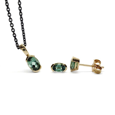 14kt yellow gold pendant and stud earrings with oval green tourmaline gemstones on black chain