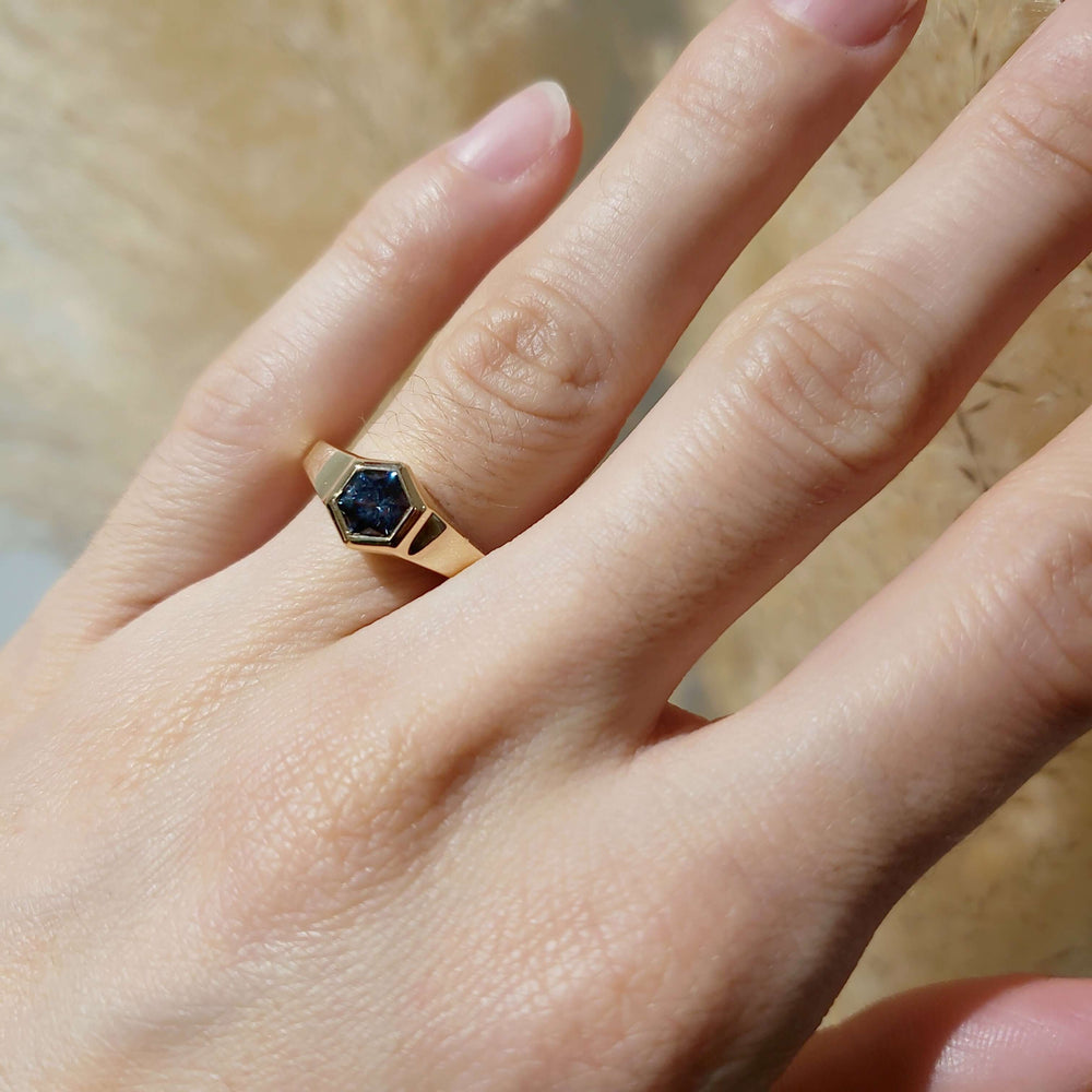 14kt yellow gold hexagon Montana sapphire ring shown on hand