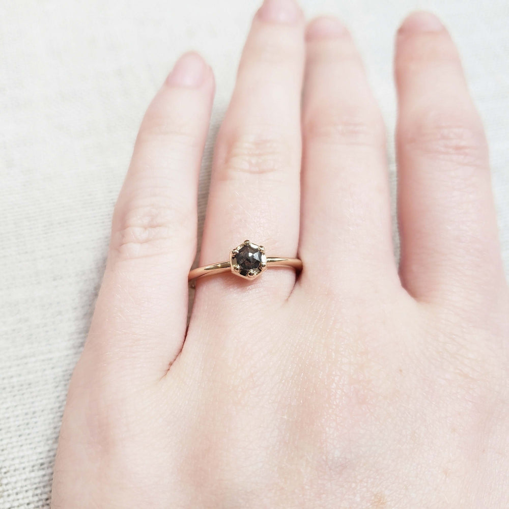 14kt yellow gold hexagon salt and pepper diamond ring worn on a hand
