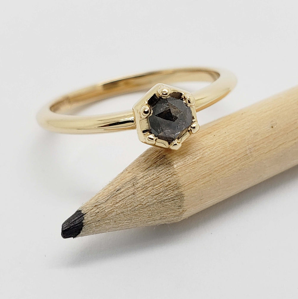 14kt yellow gold hexagon salt and pepper diamond ring shown with a pencil for scale