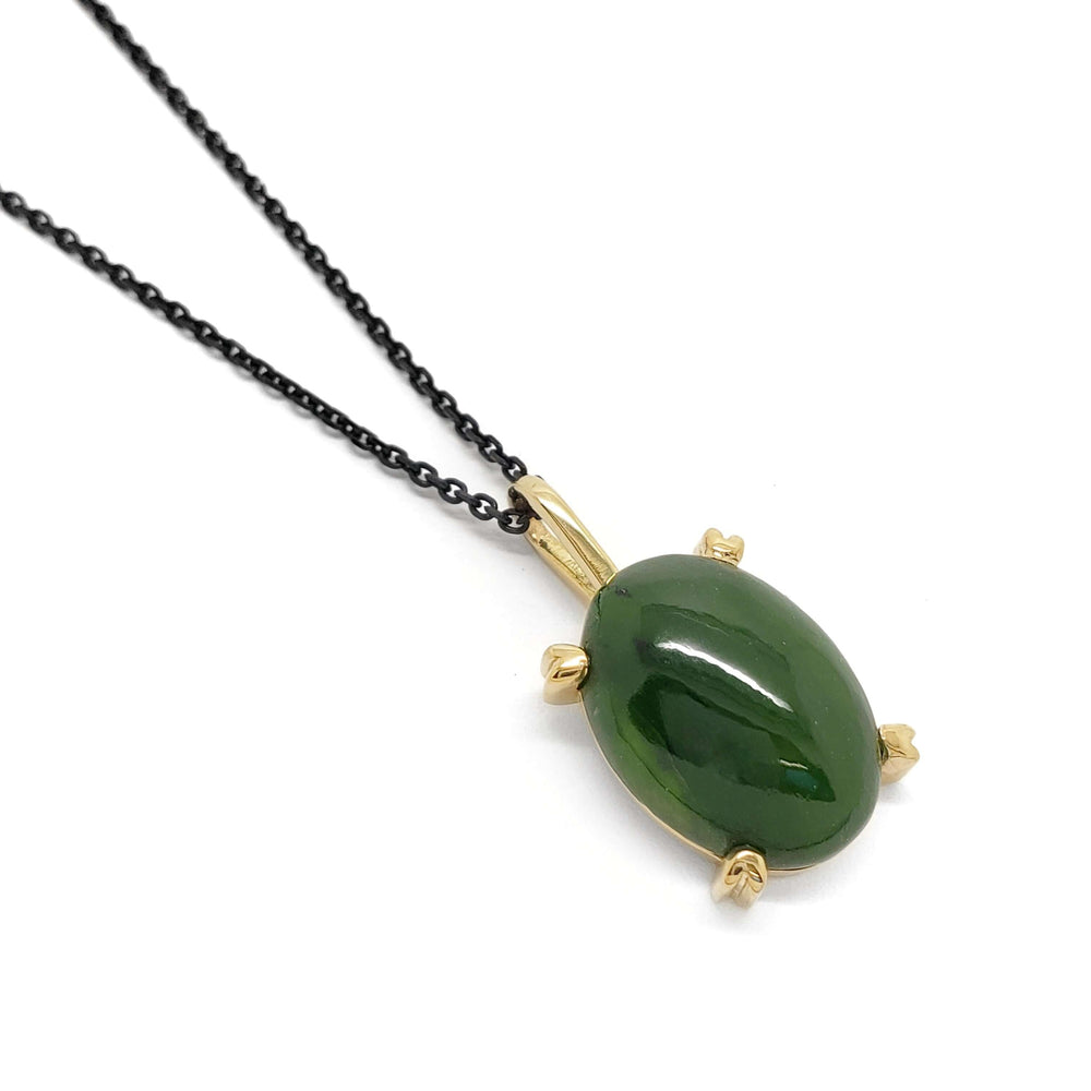 14kt yellow gold pendant with oval green jade cabochon on a dark chain
