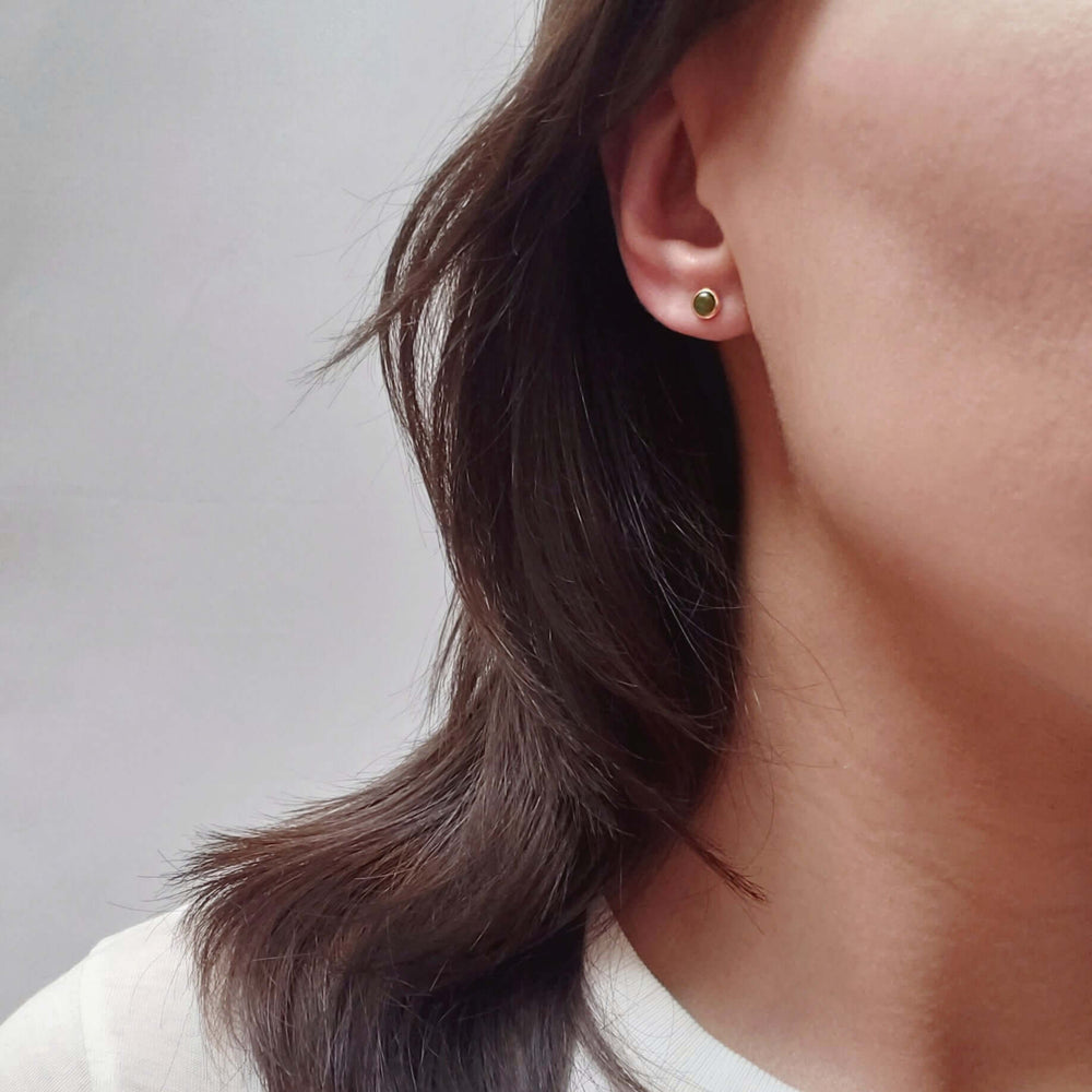 14kt yellow gold jade stud earring worn on ear