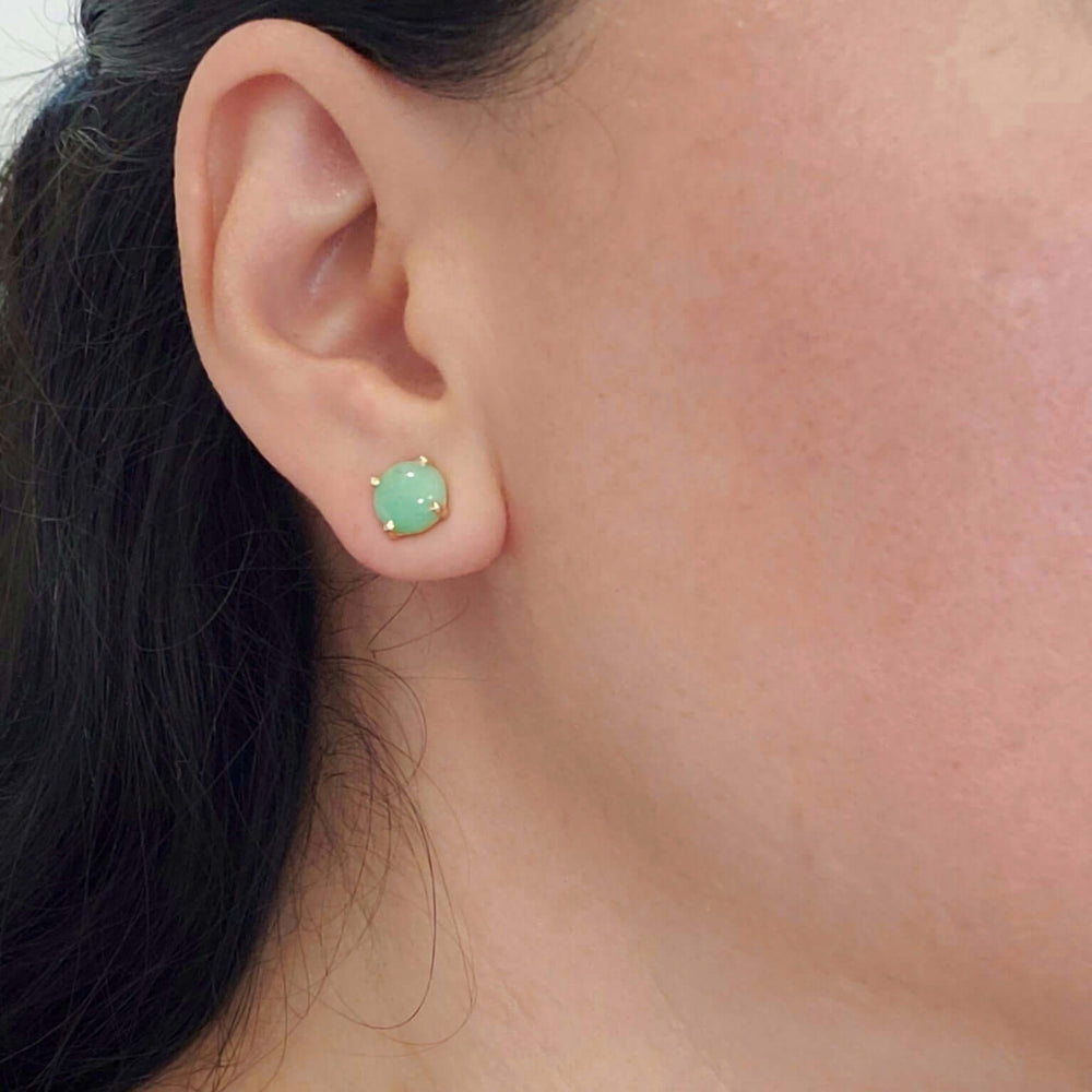 Green jade stud earring in 14kt yellow gold shown worn on ear