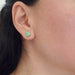 Green jade stud earring in 14kt yellow gold shown worn on ear