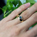 14kt yellow gold kite sapphire ring worn on hand, showing modern wide band