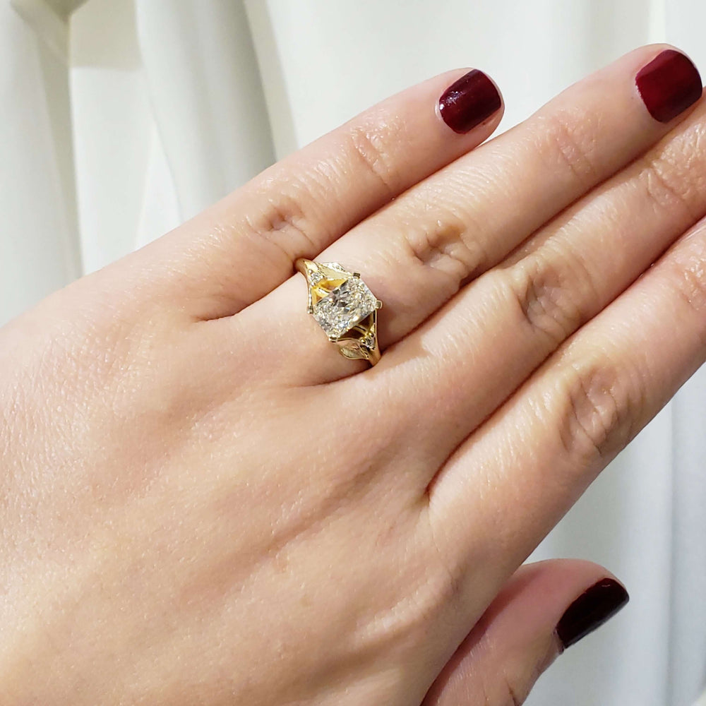 14kt yellow gold lab diamond engagement ring with leaf design shown on hand