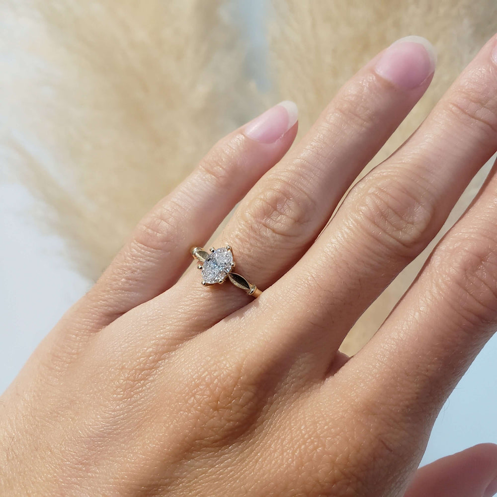 14kt yellow gold lab diamond engagement ring with leaf detail shown on hand
