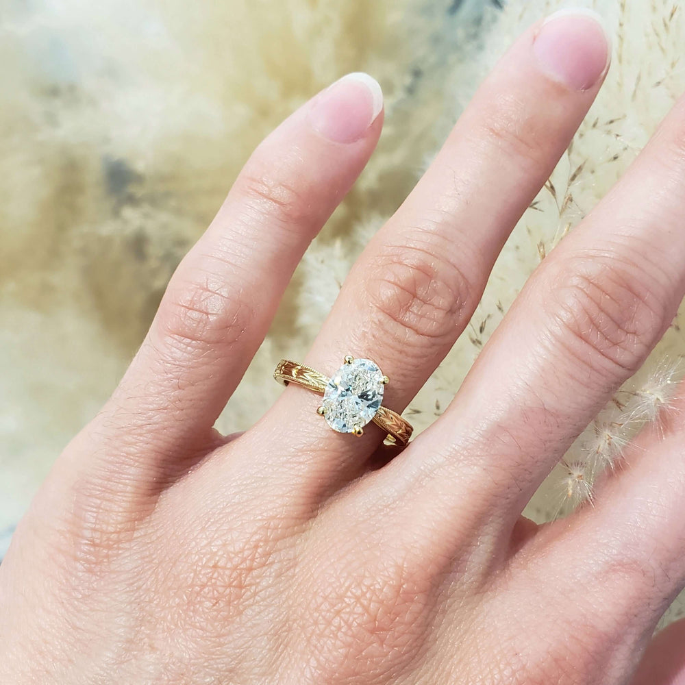 14kt yellow gold lab diamond engraved engagement ring shown on hand