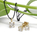 14kt yellow gold lab diamond stud earrings and matching pendant on black chain, displayed on a green stem