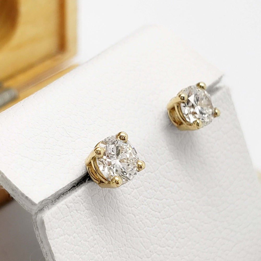 14kt yellow gold lab diamond stud earrings displayed on a white earring holder