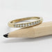 14kt yellow gold lab diamond wedding ring shown next to a pencil for scale