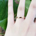 14kt yellow gold low dome wedding ring shown on a hand
