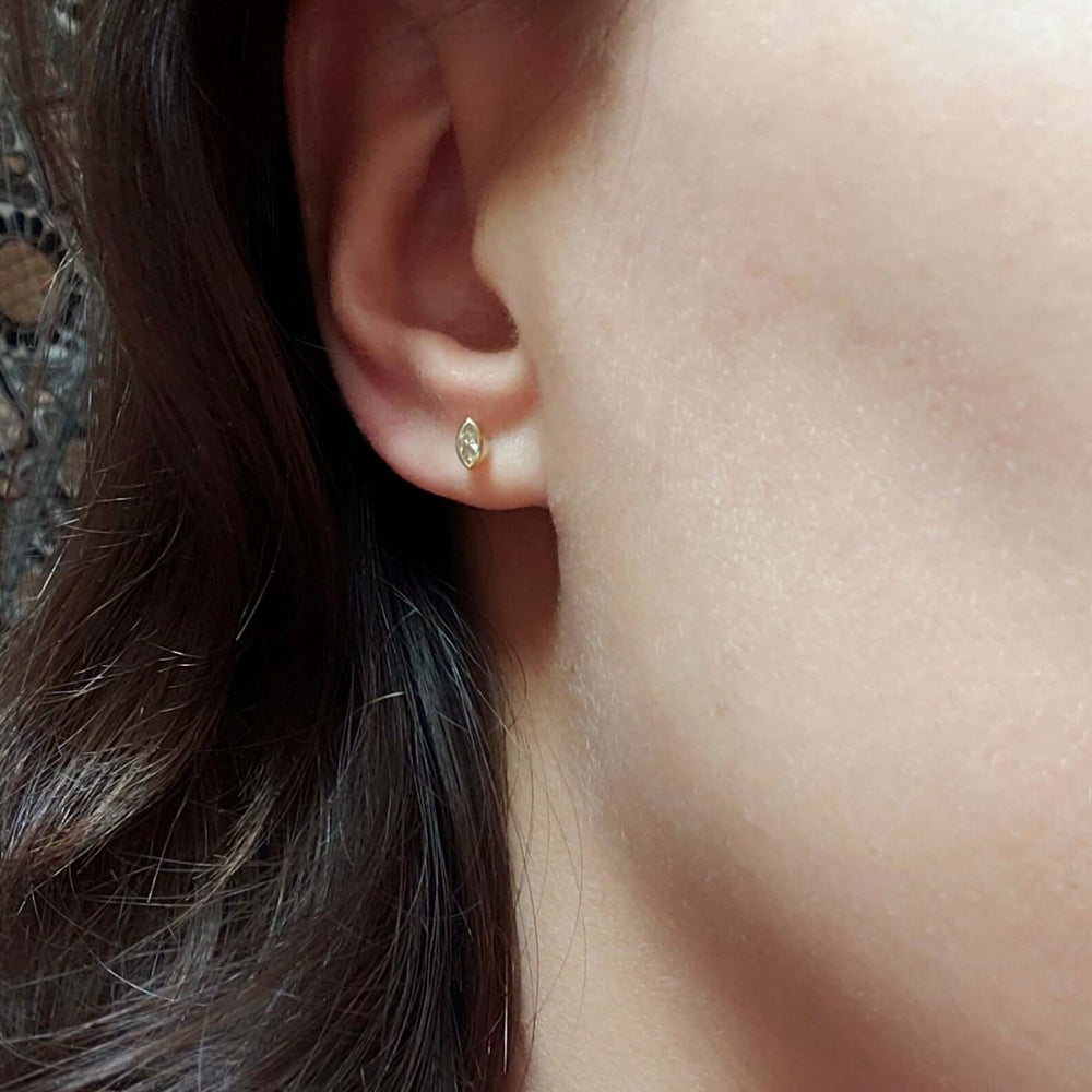 Marquise lab diamond stud earring in 14kt yellow gold worn on an ear