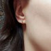 Marquise lab diamond stud earring in 14kt yellow gold worn on an ear