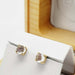 Moonstone cabochon stud earrings in 14kt yellow gold displayed in a white holder