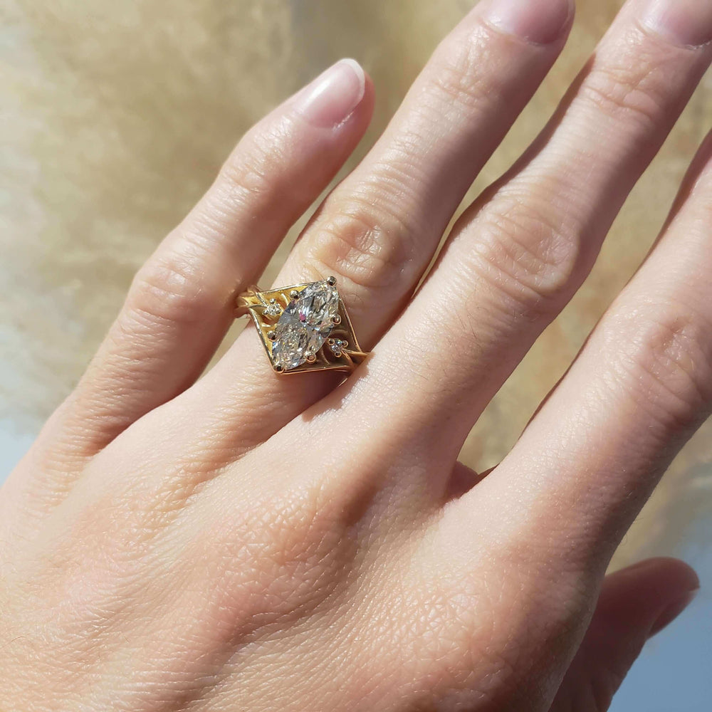 14kt yellow gold moval lab diamond engagement ring worn on hand in natural light