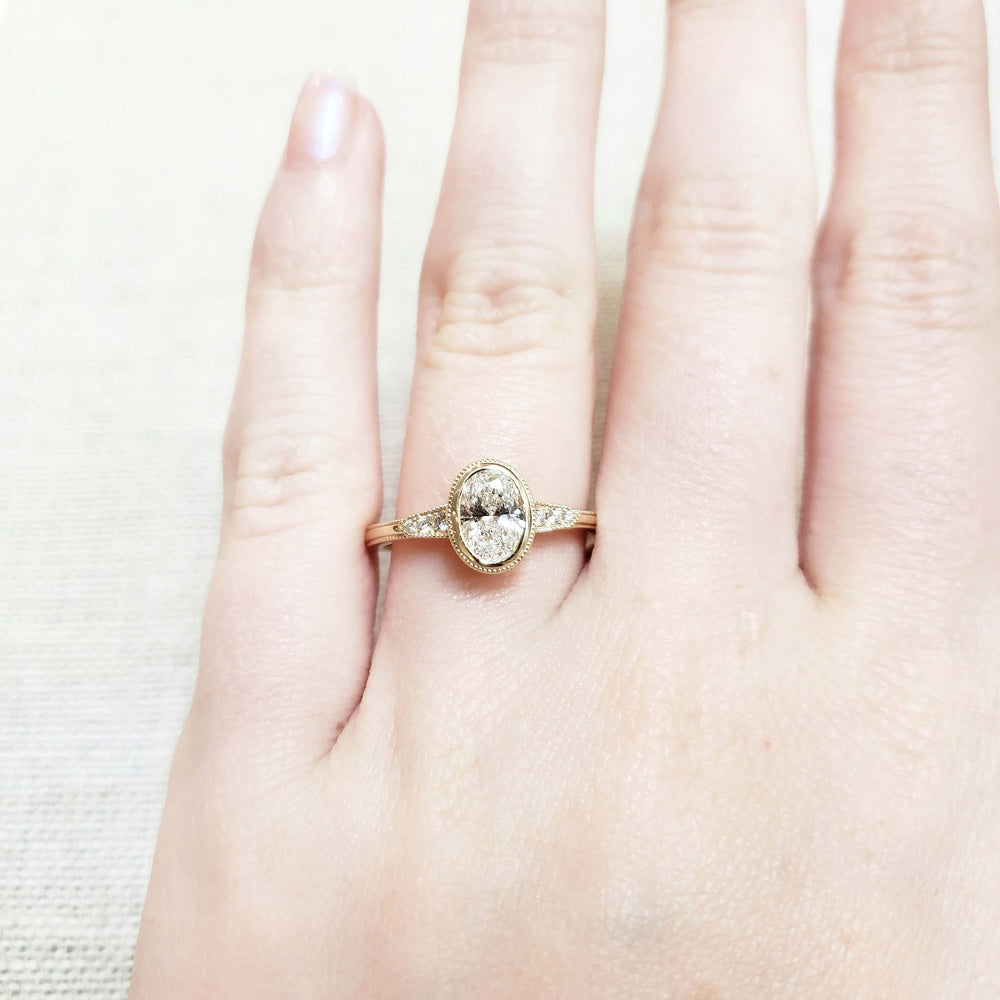 14kt yellow gold oval lab diamond engagement ring shown on a hand