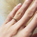 14kt yellow gold pave diamond wedding ring shown on a hand