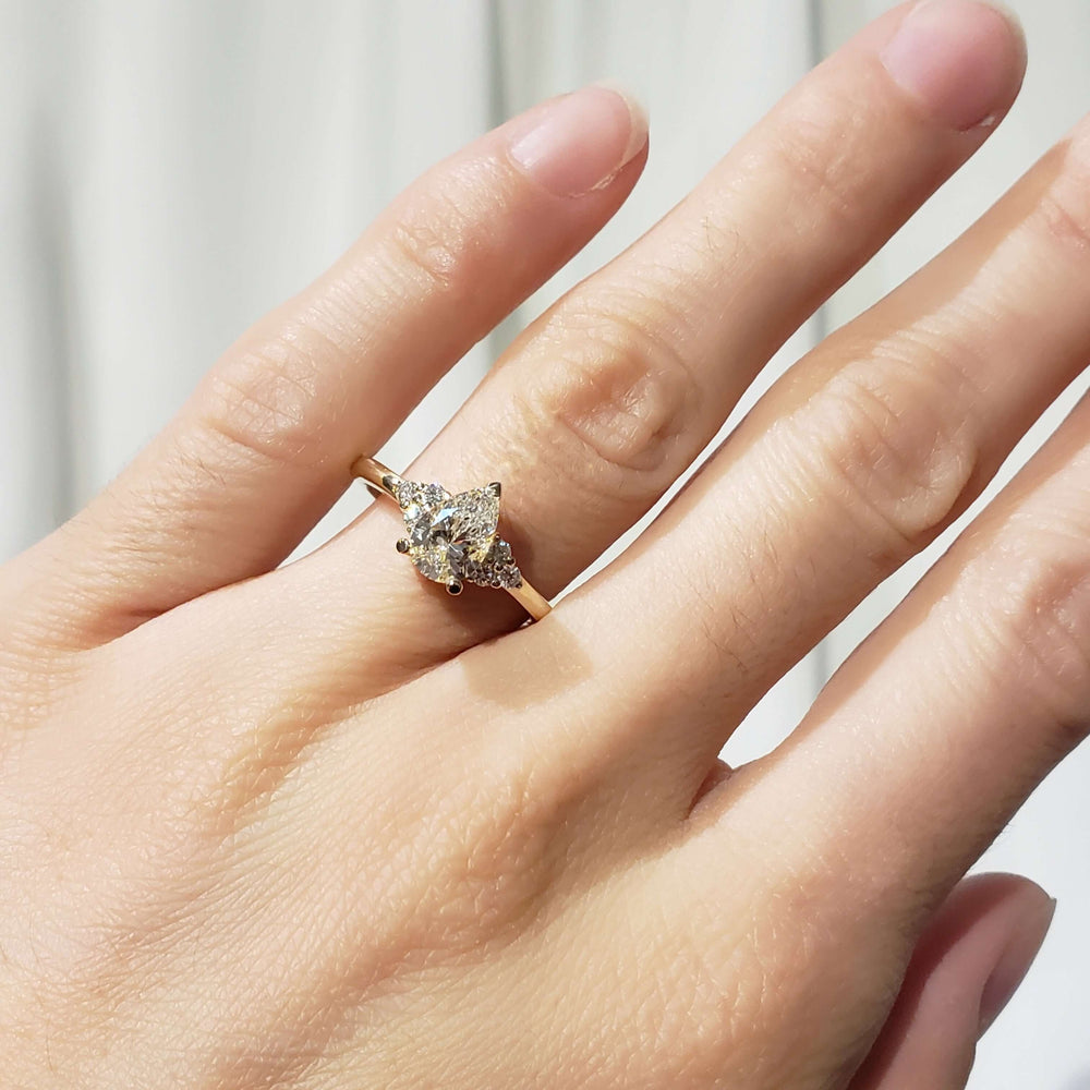 14kt yellow gold pear lab diamond engagement ring shown on hand