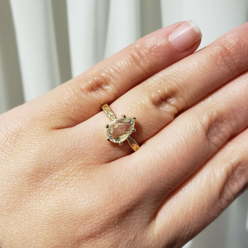 14kt yellow gold pear lab diamond ring with hand engraving shown on hand