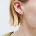 14kt yellow gold pearl chain earring worn on ear, showing freshwater pearl and chain